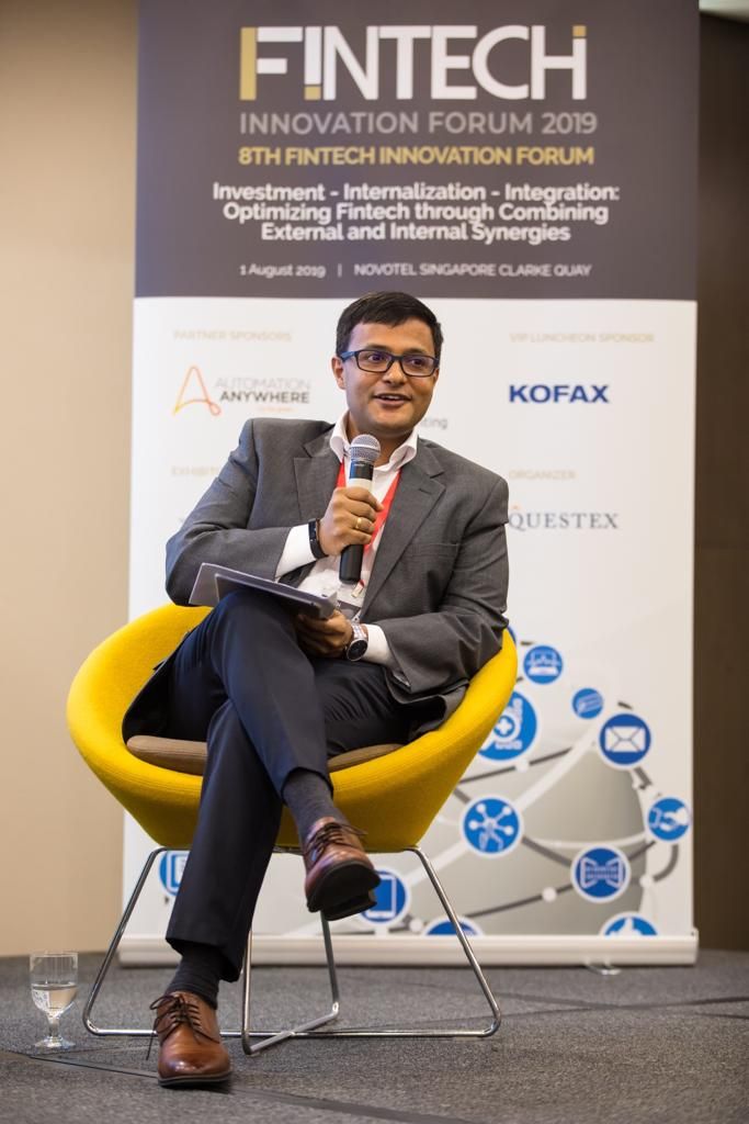 Vishnu Nanduri seated on stage with a microphone at the FinTech Innovation Forum