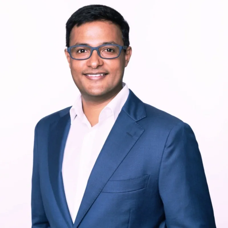 Portrait of Vishnu Nanduri in a blue jacket and white shirt