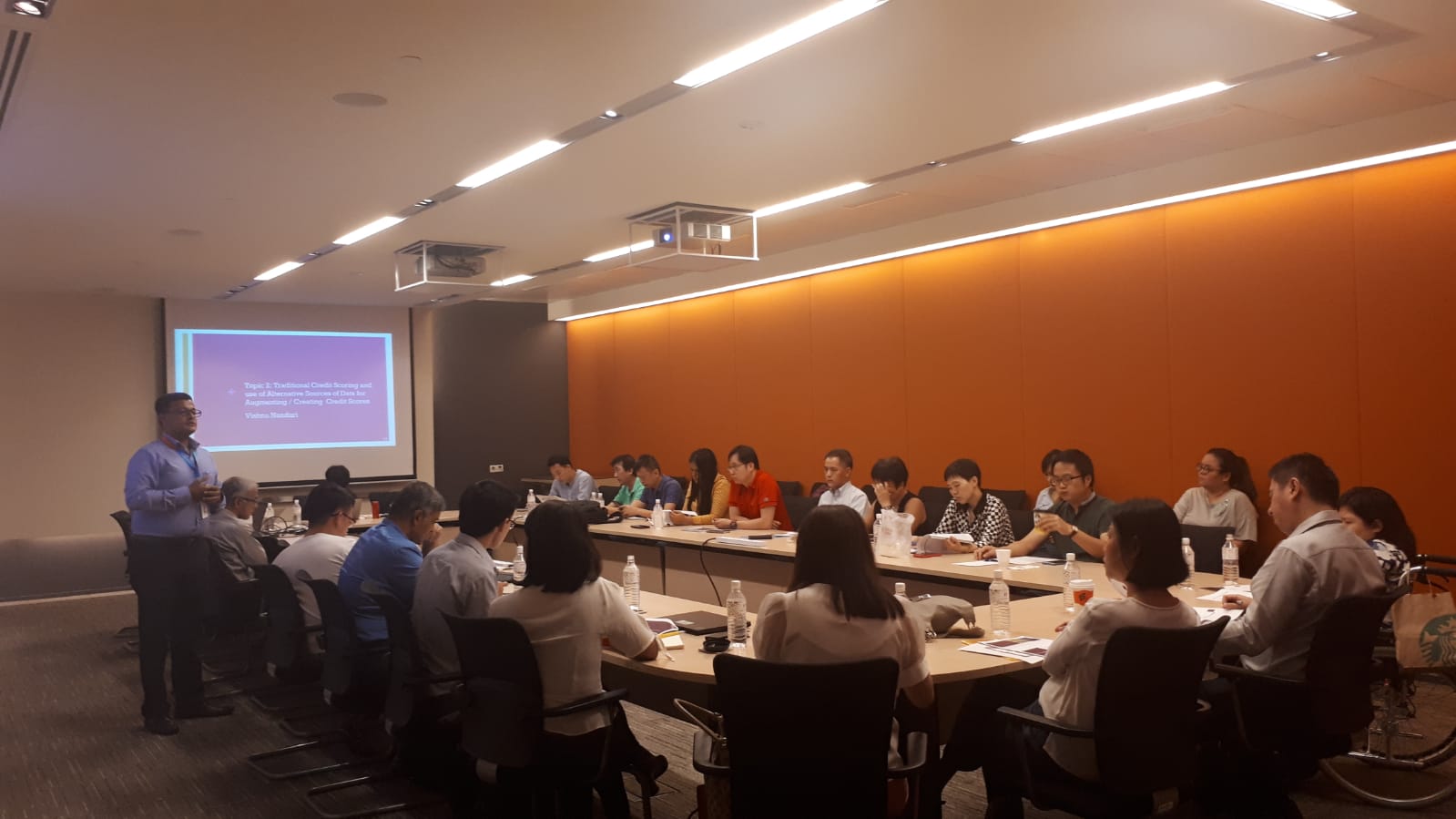 Vishnu Nanduri presenting to a full conference room