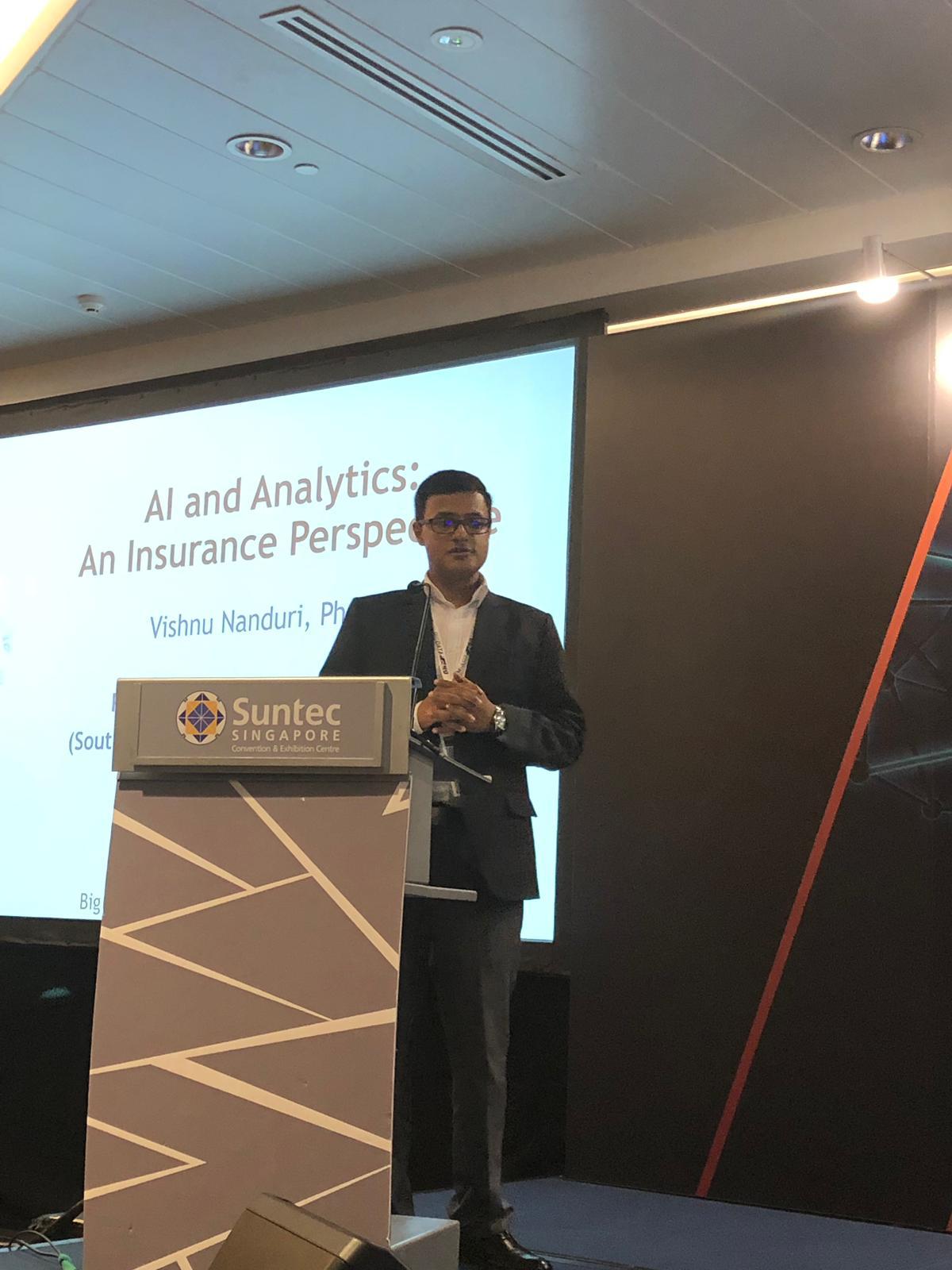 Vishnu Nanduri at the podium presenting “AI and Analytics: An Insurance Perspective” at Suntec Singapore